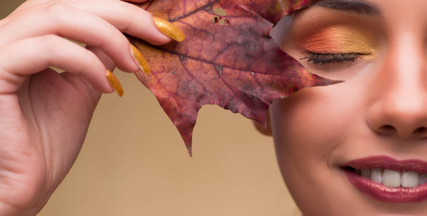 Woman with autumn leaf